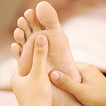 Using foot reflexology treatment to combat adrenal fatigue symptoms.